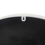 Close-up of the keyhole-shaped opening in a white tab at the upper edge of the clock's black back.