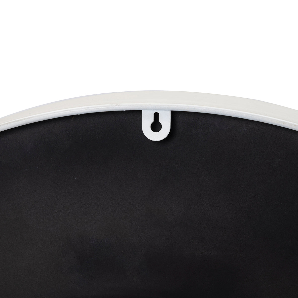 Close-up of the keyhole-shaped opening in a white tab at the upper edge of the clock's black back.