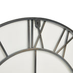 Close-up of the clock's upper rear framework, showing the curved outer ring, Roman numeral bars and hanging tab with a keyhole-shaped opening.