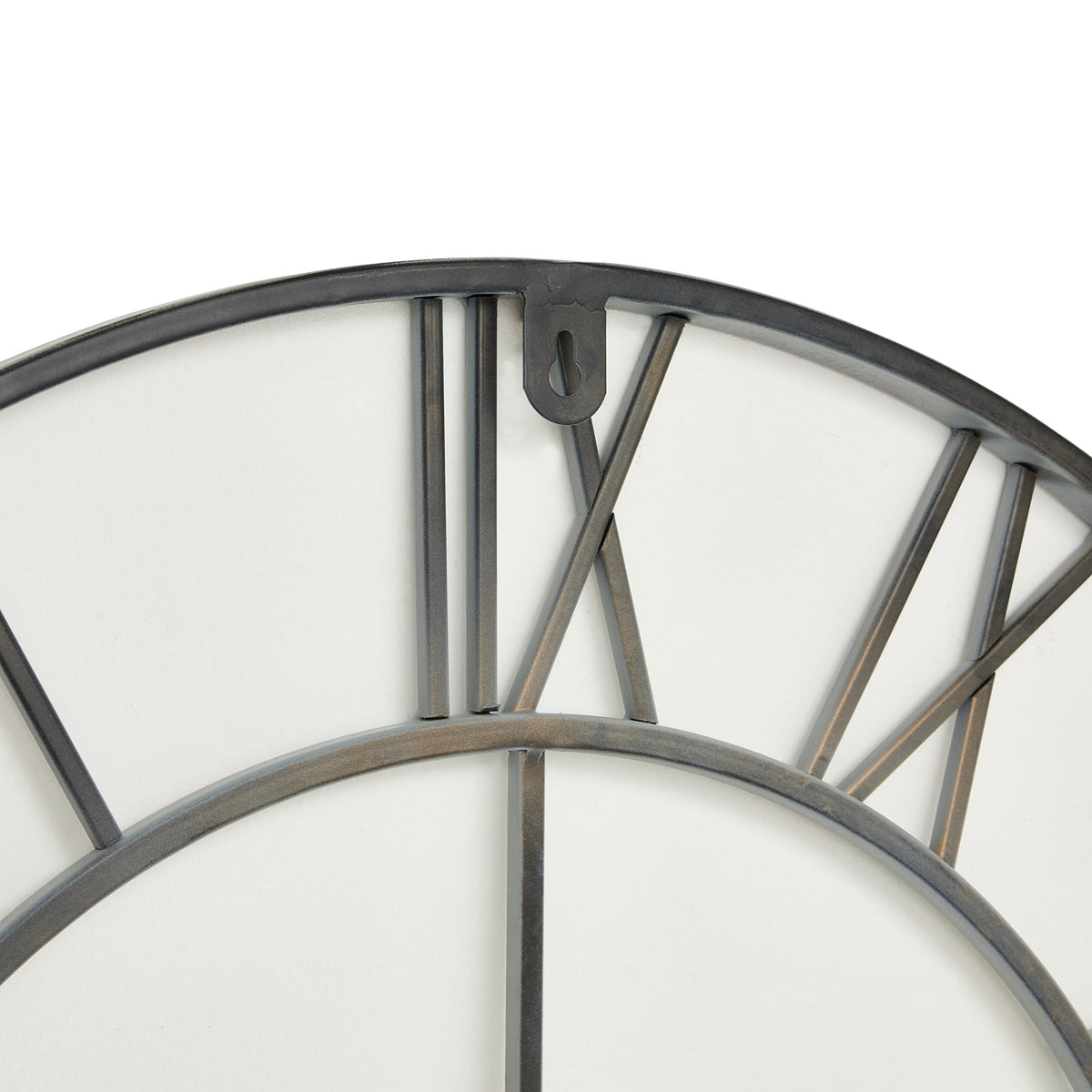 Close-up of the clock's upper rear framework, showing the curved outer ring, Roman numeral bars and hanging tab with a keyhole-shaped opening.