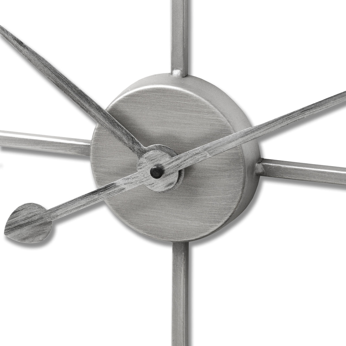 Close-up of the clock’s circular central hub and overlapping hands, showing the rubbed, brushed-looking silver-toned surface.