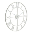 Angled front view of the white round skeleton wall clock, showing open Roman numerals, concentric rings and three shaped hands.