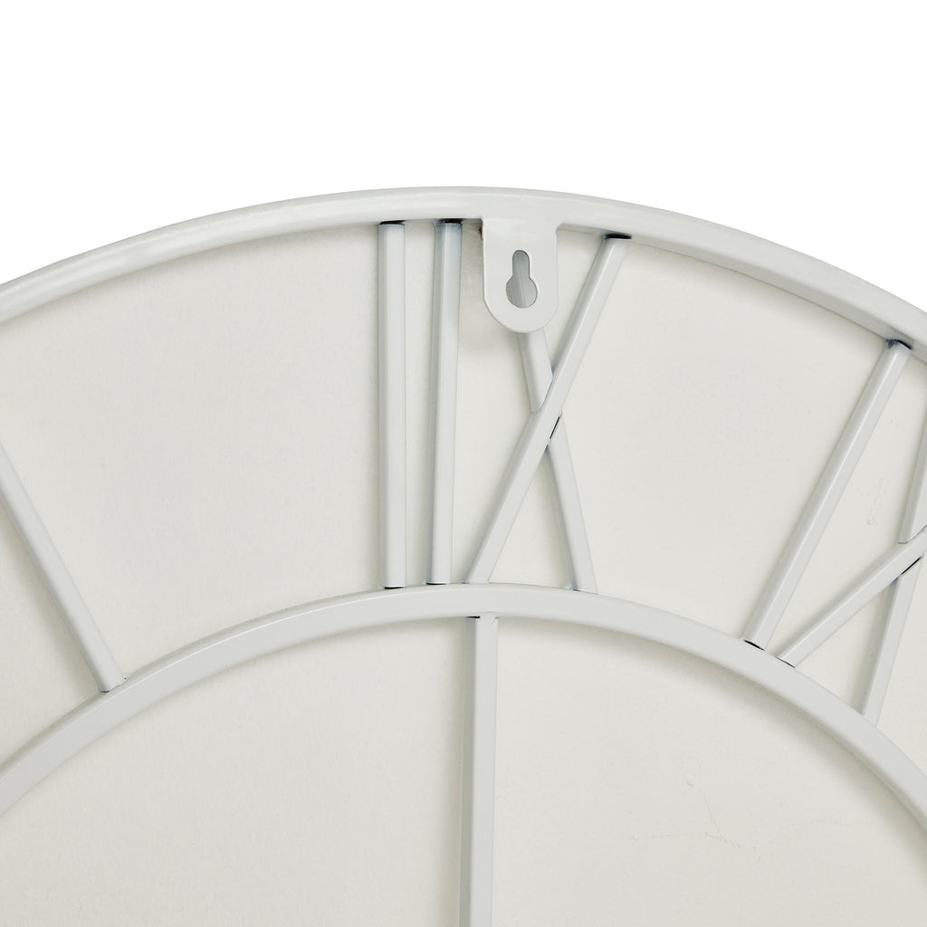 Rear close-up at the top of the white clock, showing the XII numeral framework, curved outer and inner rings and keyhole-cut hanging tab.