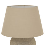 Close-up of the broad tapered beige lampshade, showing its fine woven appearance, open upper rim and part of the textured base below.