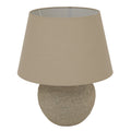 Rough Lowbase Table Lamp on a white background, showing its rounded mottled grey-beige base and broad tapered beige shade.