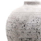 Close-up of the vase's curved shoulder and short neck, showing fine rough texture above dark speckles, streaks and bands.