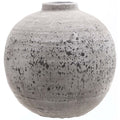 Rounded grey-beige vase with a short open neck, rough surface and irregular dark speckles and horizontal bands against a white background.