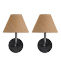 Front view of two matching wall lights with dark round backplates, curved arms and tapered tan fabric shades on a white background.