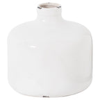 White round vase with broad curved shoulders, a short neck and dark worn-looking patches on the rim and base.