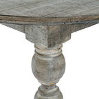 Close-up of the dining table's curved profiled edge and the upper section of a leg beneath it.
