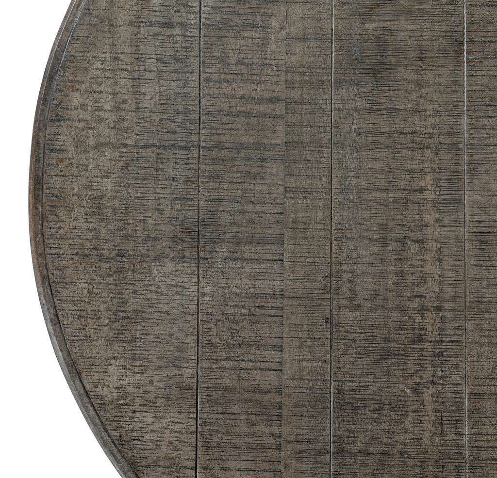 Overhead detail of the round tabletop, showing long parallel lines, fine crossing marks and part of the curved rim.
