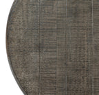 Overhead detail of the round tabletop, showing long parallel lines, fine crossing marks and part of the curved rim.