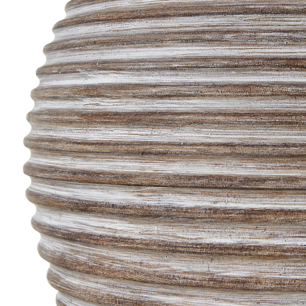 Close-up of the lamp base showing brown horizontal ridges with pale streaks and a mottled surface.