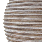 Close-up of the lamp base showing brown horizontal ridges with pale streaks and a mottled surface.