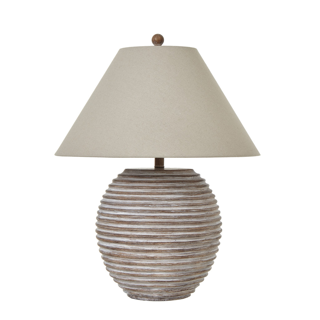 Rounded brown table lamp with horizontal ribs, a broad pale tan shade and round top finial on a white background.