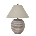 Rounded brown table lamp with horizontal ribs, a broad pale tan shade and round top finial on a white background.