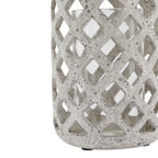 Close-up of the lantern's lower diamond lattice, with dark grey flecks across the pale surface and the clear cylinder visible behind it.