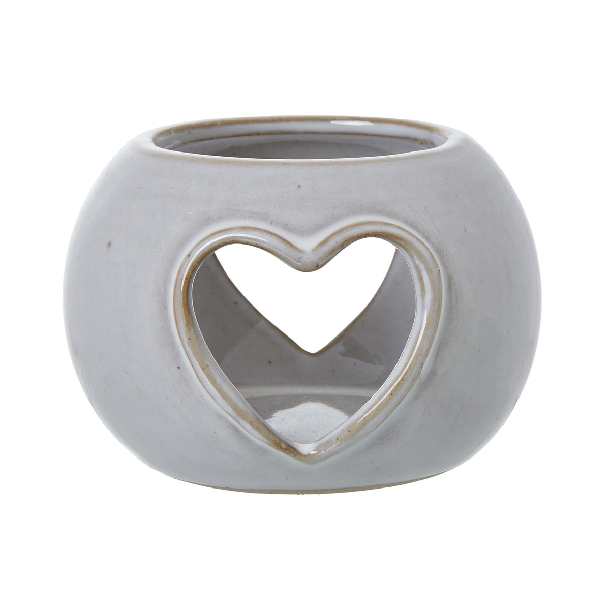 Front view of the rounded off-white candle holder, showing a tan-edged heart opening and a second heart visible through it.