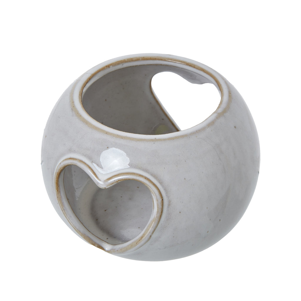Angled view from above showing the candle holder's open top, glossy speckled surface and heart cut-outs on opposite sides.