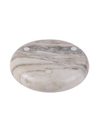 Underside of the marble bowl with bands of natural veining and three pale circular pads.