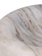 Close-up of the bowl's curved inner edge, showing pale beige stone with grey bands and fine brown veins.