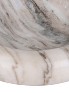 Detail of the rounded marble rim and interior, with warm brown veins crossing the pale polished surface.