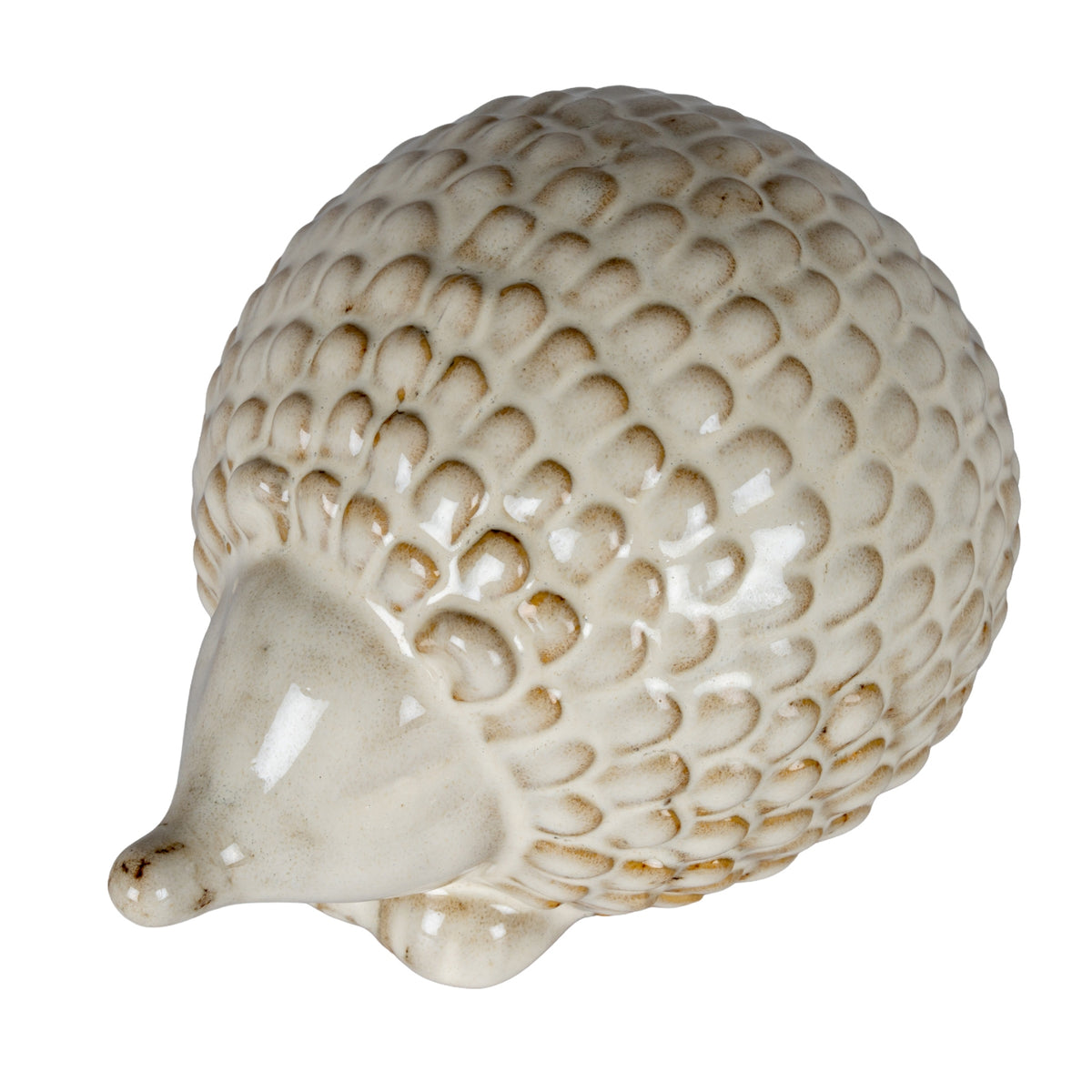 Hedgehog decoration viewed from above at an angle, showing the high domed back covered in rounded cream scales and the smooth face pointing towards the lower left.