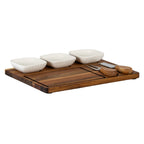 Low angled view of the board with three white bowls across the back, a two-prong fork and broad flat blade on the right, and the inset area in front.
