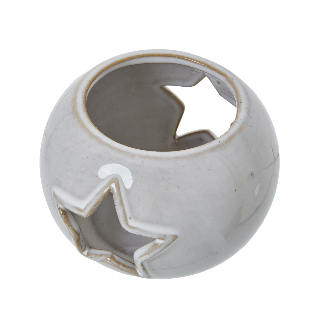Angled view from above showing the candle holder's circular opening, glossy curved surface and star cut-outs in the sides.
