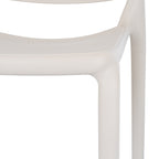 Close-up of the putty chair's seat edge and legs, showing the fine pebbled texture and curved outline beside the back.