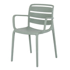 Front three-quarter view of a pale green-grey dining chair with three curved back panels, open arms and four slim legs.
