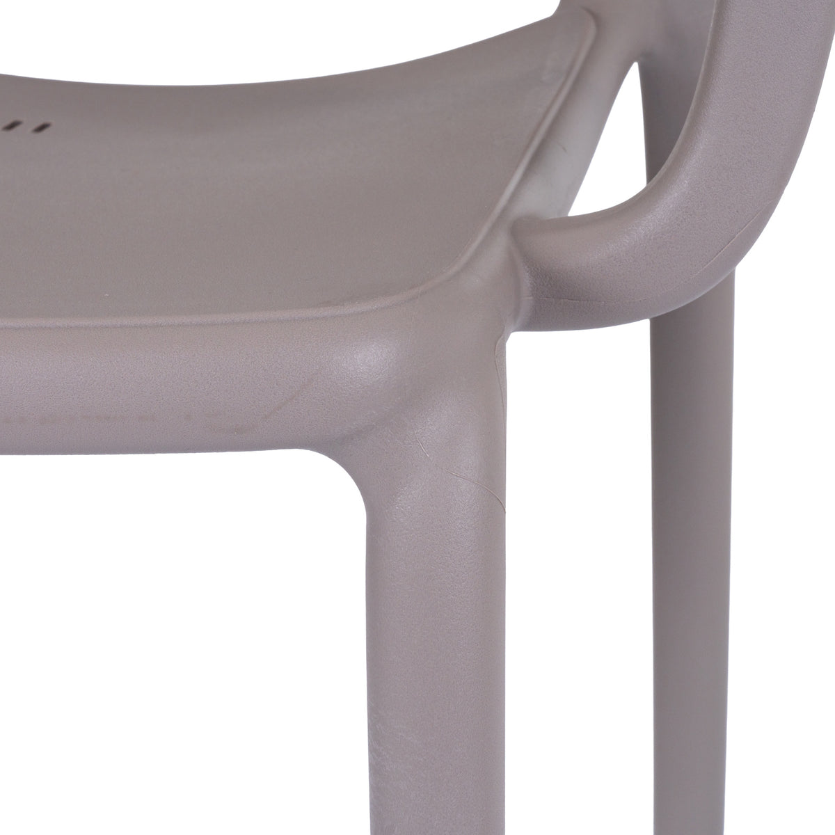 Close-up of the grey chair's seat edge, curved arm and legs, showing the fine pebbled surface texture.