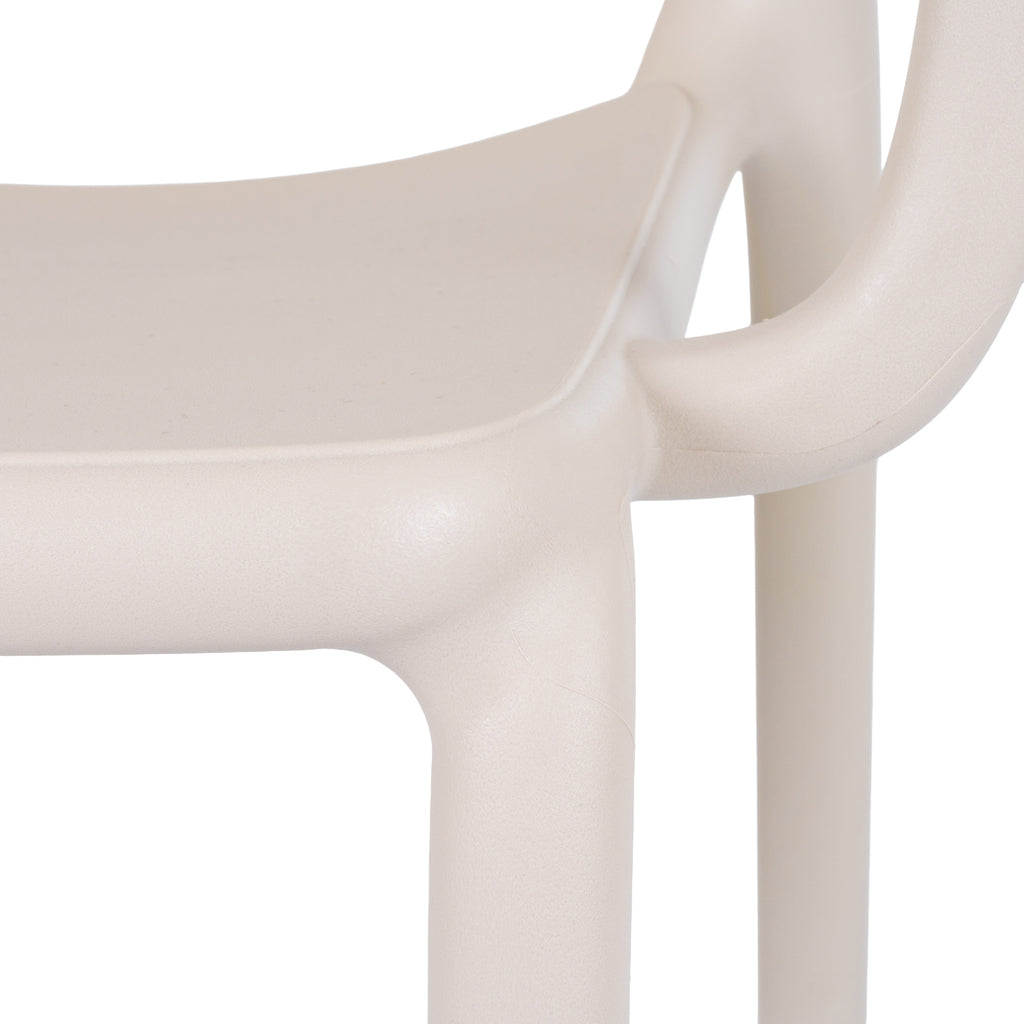 Close-up of the putty chair's seat edge, curved arm and front leg, showing the fine pebbled surface texture.