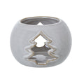 Front view of a rounded off-white candle holder with brown speckles, an open top and a tan-edged tree cut-out.