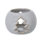 Front view of a rounded off-white candle holder with brown speckles, an open top and a tan-edged tree cut-out.