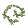 Roundleaf Trail foliage garland arranged in a loose spiral on white, showing rounded green leaves, fine sprigs, small pinecones and an end loop.