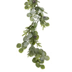 Close-up of the garland's overlapping rounded leaves, needle-like green sprigs and brown pinecones with a pale frosted appearance.