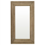 Front view of the tall rectangular wall mirror with a broad moulded brown frame and pale rubbed markings.