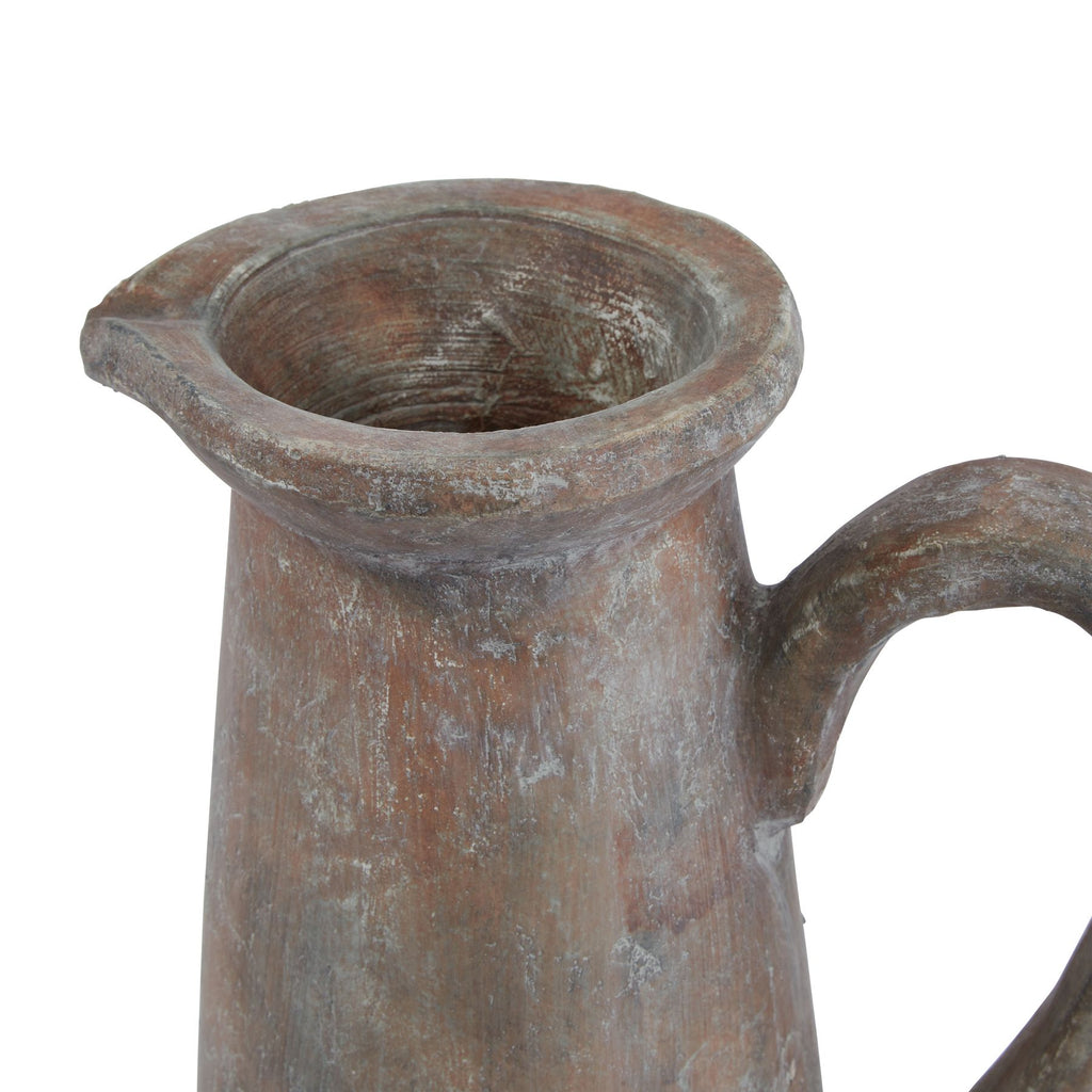 Close view of the jug's wide opening and flared rim, showing grey mottling across the brown surface and the top of the curved handle.