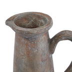 Close view of the jug's wide opening and flared rim, showing grey mottling across the brown surface and the top of the curved handle.