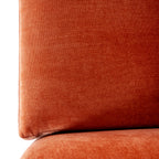 Close-up of a rust-orange back cushion showing the fine surface texture and its lower edge above the seat.