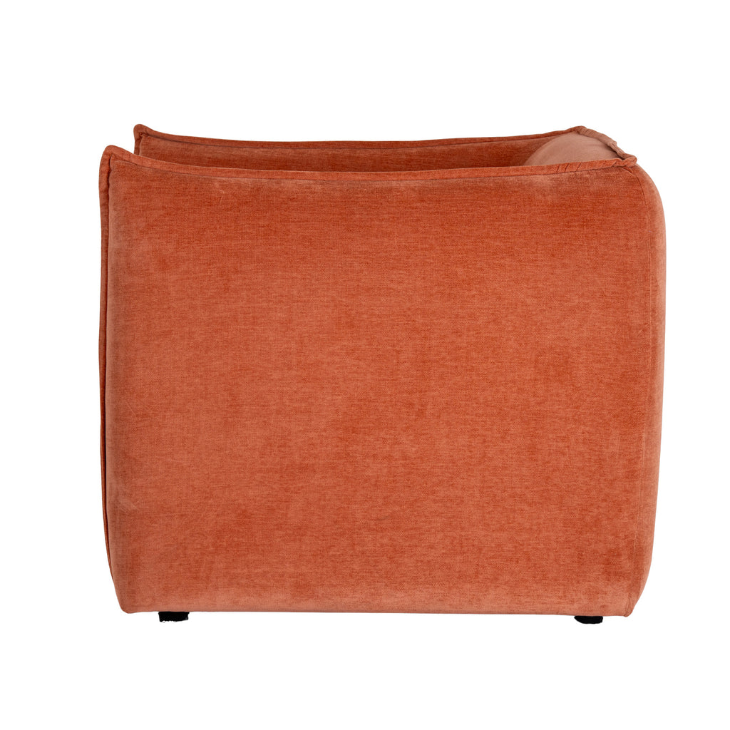 Rear view of the rust-orange armchair, showing its broad rounded back, raised edging and short dark feet.