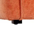 Close-up of a short dark rectangular foot with a small rounded pad beneath the rust-orange upholstered chair base.