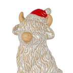 Close-up of the cow decoration's head and upper body, showing raised cream coat texture over tan, side ears, horns and a glossy red hat with textured pale trim.