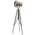 Grey tripod floor lamp shown at an angle on a white background, with a barrel-shaped spotlight head, top handle and copper fixings.