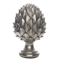 Silver-coloured pinecone finial with layered pointed scales, a narrow pedestal neck and rounded stepped base against white.