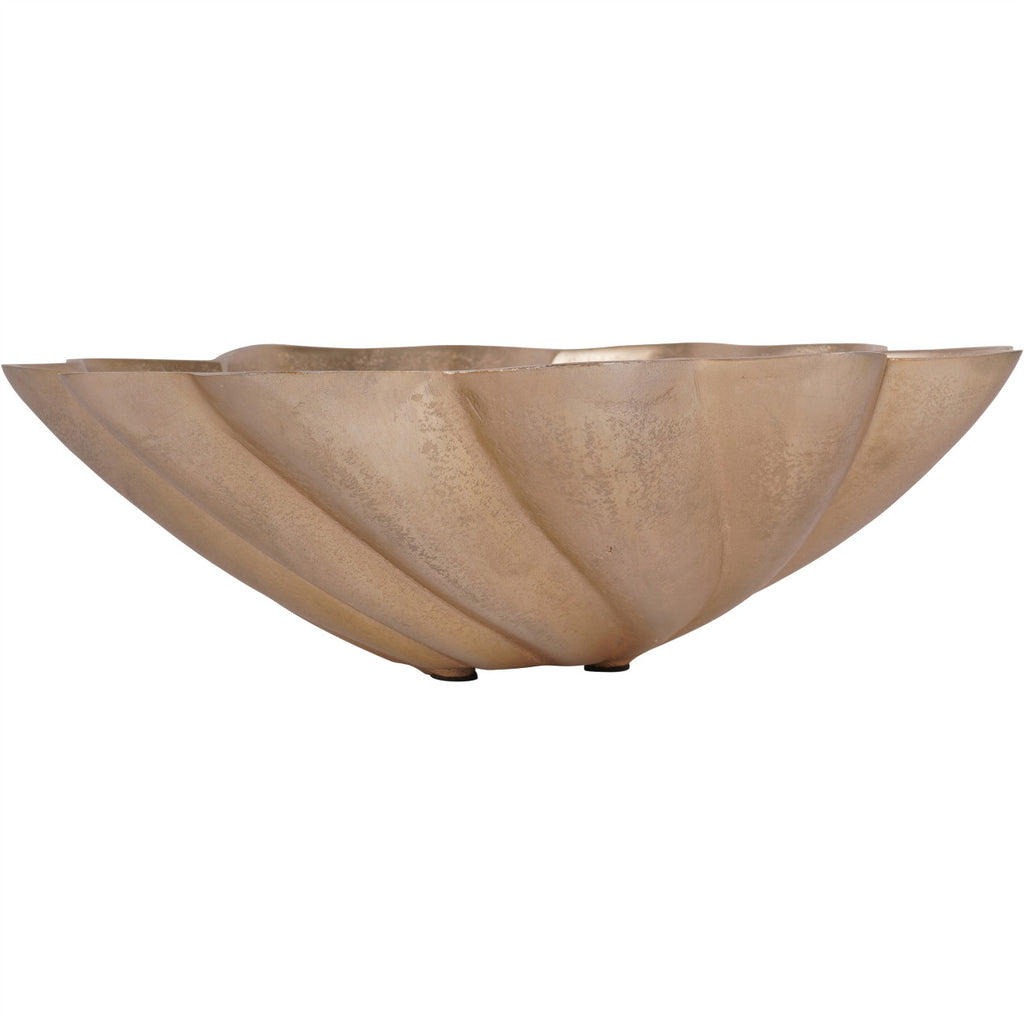 Side view of the gold bowl showing its curved outer ridges and small dark feet.