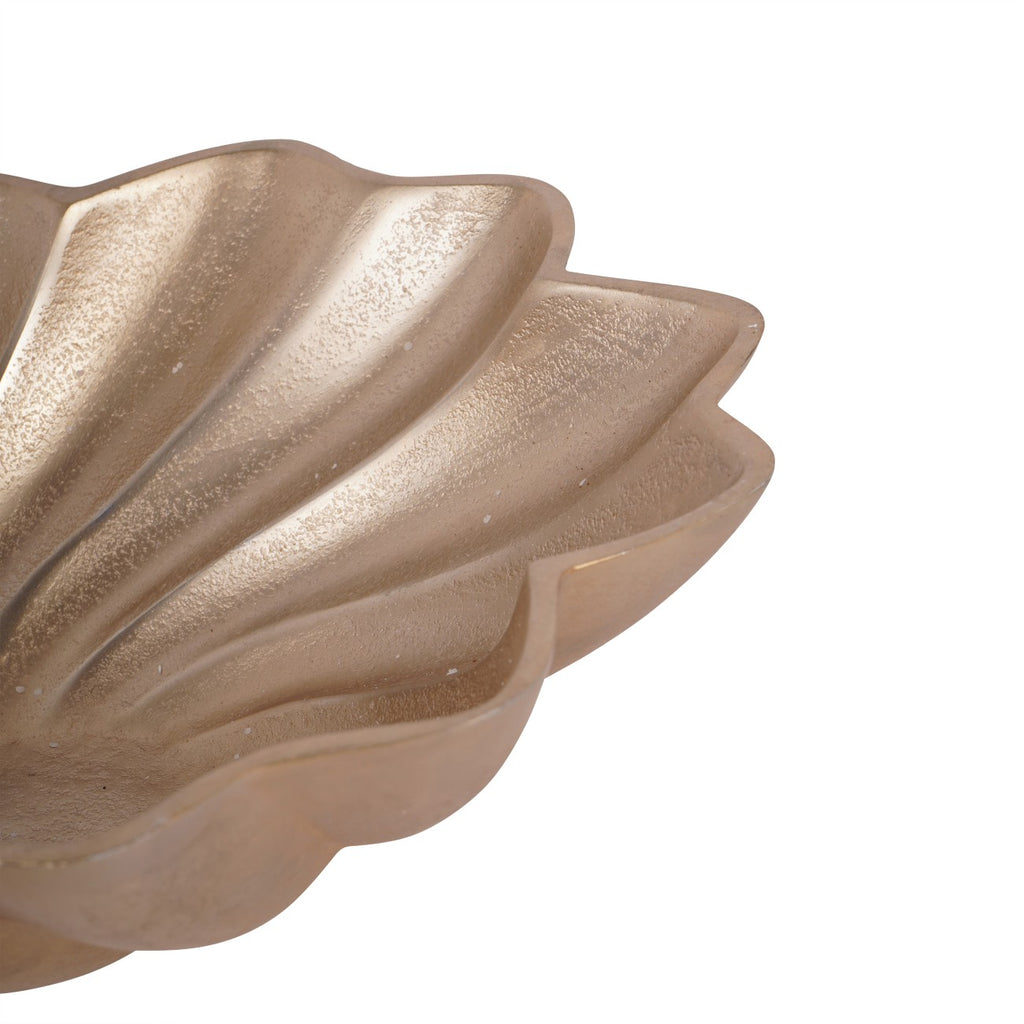 Close-up of the bowl's right-hand scalloped edge, curved grooves and textured gold surface.