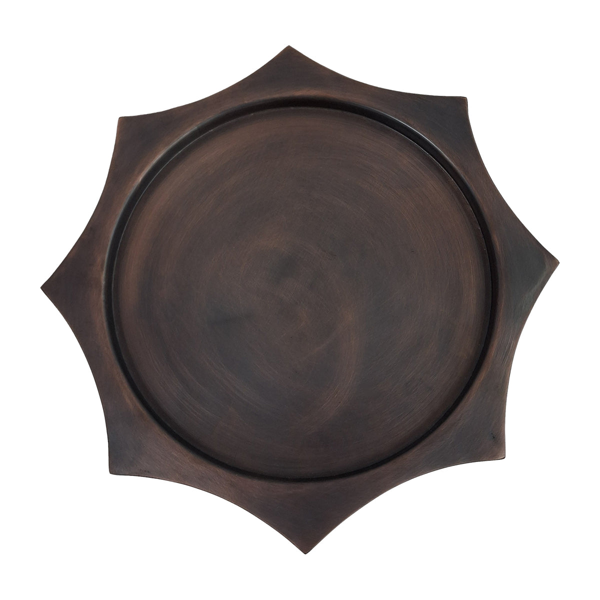 Overhead view of the circular bronze display surface surrounded by the scalloped hexagonal edge.