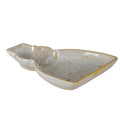 Low angled view of the glossy off-white snowman dish, showing its shallow rim, beige edging and raised stars.
